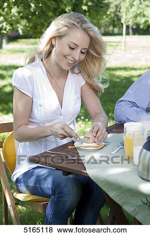 Young woman having breakfast View Large Photo Image Stock Photo - Young woman having breakfast . Fotosearch