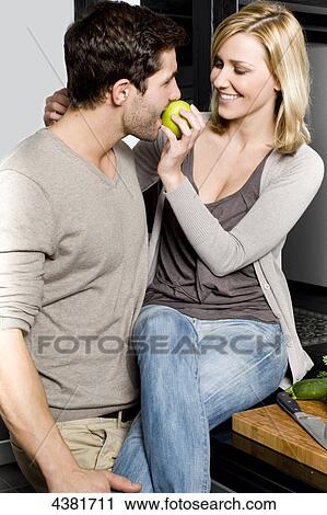 Stock Image - Young woman in kitchen . Fotosearch