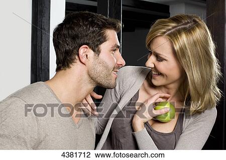 Stock Image - Young woman in kitchen . Fotosearch