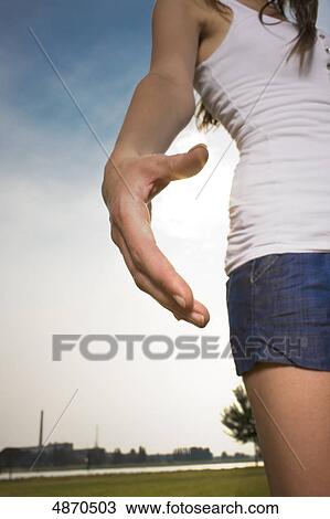 Young woman in shorts and top in meadow View Large Photo Image Stock Image - Young woman in shorts and top in meadow . Fotosearch