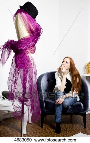 Young woman looking at tailor's dummy View Large Photo Image Stock Image - Young woman looking at tailor's dummy . Fotosearch