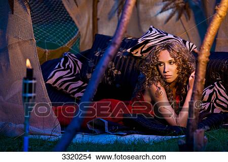 Young woman lying in a tent View Large Photo Image Picture - Young woman lying in a tent . Fotosearch