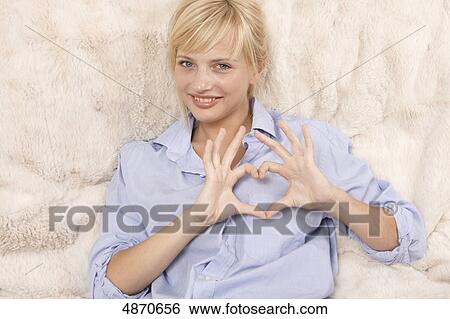 Young woman making heart with her hands View Large Photo Image Stock Photograph - Young woman making heart with her hands . Fotosearch