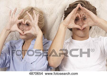 Young woman making hearts with her hands View Large Photo Image Picture - Young woman making hearts with her hands . Fotosearch