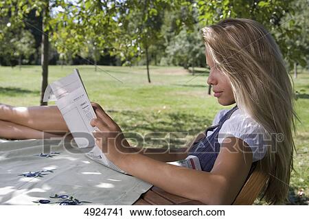 Young woman reading in park View Large Photo Image Stock Image - Young woman reading in park . Fotosearch