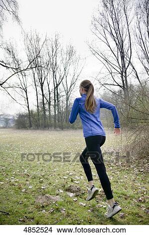 Picture - Young woman running . Fotosearch
