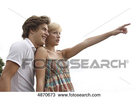 Young woman showing something to her boyfriend outdoors View Large Photo Image Stock Image - Young woman showing something to her boyfriend outdoors . Fotosearch