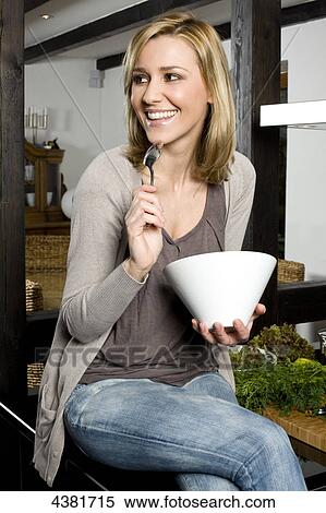 Young woman sitting in kitchen View Large Photo Image Stock Photography - Young woman sitting in kitchen . Fotosearch