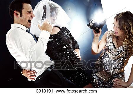 Stock Image - Young woman taking a picture of young couple . Fotosearch