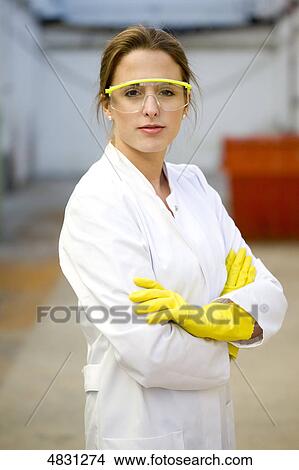 Young woman with lab coat and protective glasses View Large Photo Image Picture - Young woman with lab coat and protective glasses . Fotosearch