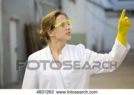 Young woman with lab coat and protective glasses View Large Photo Image Stock Image - Young woman with lab coat and protective glasses . Fotosearch