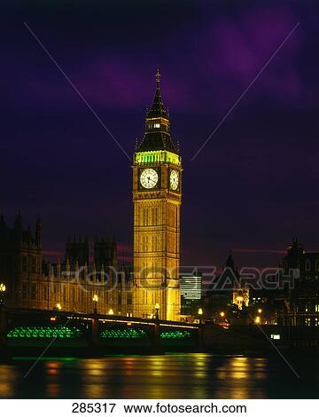 Stock Photo - Bell tower lit up at night, Westminster Bridge, Big Ben, Thames River, Houses Of Parliament, London, England . Fotosearch
