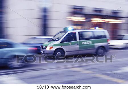 Stock Image - Blurred view of police car on road . Fotosearch