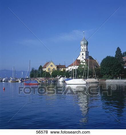 Stock Photo - Boats in harbor, St. Georg Church, Wasserburg, Lake Constance, Baden-Wurttemberg, Germany . Fotosearch