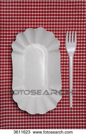 Stock Image - Bowl and plastic fork on a checkered tablecloth . Fotosearch