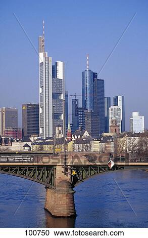 Bridge across river with skyscrapers in background, Ignatz Bubis Bridge, River Main, Frankfurt, Hesse, Germany View Large Photo Image Stock Image - Bridge across river with skyscrapers in background, Ignatz Bubis Bridge, River Main, Frankfurt, Hesse, Germany . Fotosearch