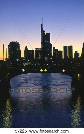 Stock Photography - Bridge in front of buildings at dusk, Ignatz-Bubis-Brucke, Main River, Frankfurt, Hesse, Germany . Fotosearch