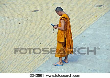 Buddhist monk looking at mobile phones, Angkor, Cambodia, elevated view View Large Photo Image Stock Image - Buddhist monk looking at mobile phones, Angkor, Cambodia, elevated view . Fotosearch