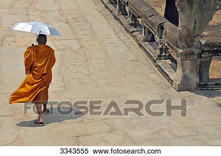 Stock Photography - Buddhist monk with umbrella, Angkor, Cambodia, rear view . Fotosearch