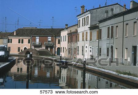 Stock Image - Buildings near canal, Comacchio, Province Of Ferrara, Emilia-Romagna, Italy . Fotosearch