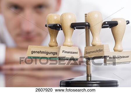 Businessman looking at stamps View Large Photo Image Stock Image - Businessman looking at stamps . Fotosearch