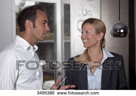 Businesswoman and businessman talking View Large Photo Image Stock Photograph - Businesswoman and businessman talking . Fotosearch