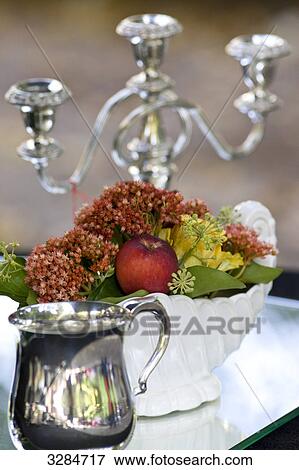 Candleholder, flower vase and cannikin on a glass table, close-up View Large Photo Image Stock Photo - Candleholder, flower vase and cannikin on a glass table, close-up . Fotosearch