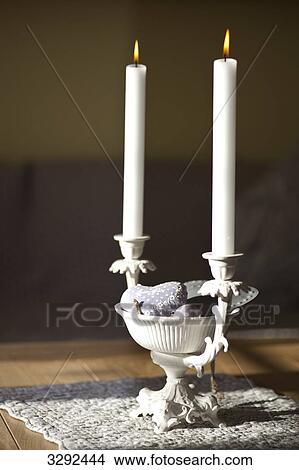 Picture - Candleholder with candles on a table, close-up . Fotosearch