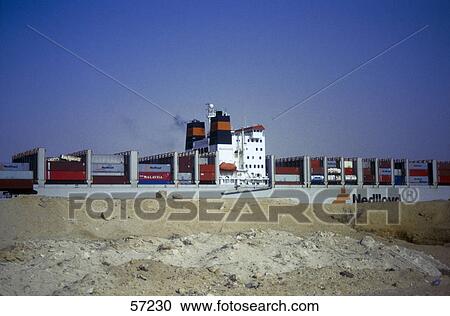 Cargo ship in canal against blue sky, Suez Ship Canal, Egypt View Large Photo Image Stock Image - Cargo ship in canal against blue sky, Suez Ship Canal, Egypt . Fotosearch