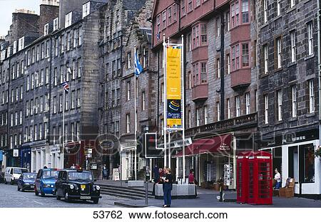 Stock Image - Cars in shopping street, Royal Mile, Lawnmarket, Edinburgh, Scotland . Fotosearch