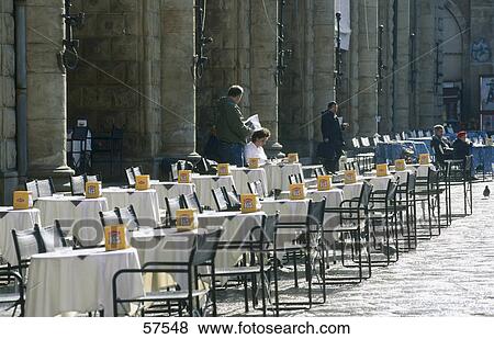 Chairs and tables at a sidewalk cafe, Piazza Maggiore, Bologna, Emilia-Romagna, Italy View Large Photo Image Stock Photo - Chairs and tables at a sidewalk cafe, Piazza Maggiore, Bologna, Emilia-Romagna, Italy . Fotosearch