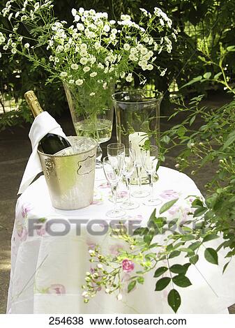 Champagne bottle in ice bucket on table View Large Photo Image Stock Photo - Champagne bottle in ice bucket on table . Fotosearch