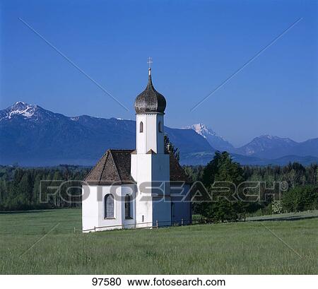 Stock Image - Chapel with mountain in background, Penzberg, Weilheim-Schongau, Bavaria, Germany . Fotosearch