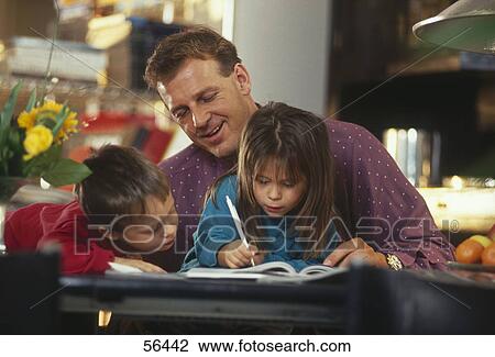 Children studying with their father in living room View Large Photo Image Stock Image - Children studying with their father in living room . Fotosearch