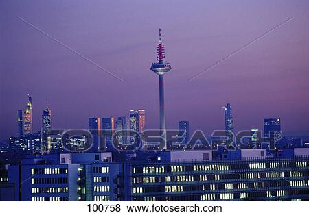 Stock Photo - Cityscape lit up at dusk . Fotosearch
