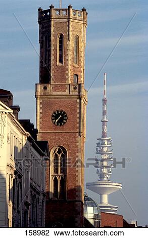 Stock Image - Clock tower in front of communication tower . Fotosearch
