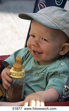 Close-up of baby in pram with bottle View Large Photo Image Stock Photo - Close-up of baby in pram with bottle . Fotosearch