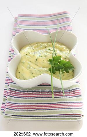Stock Image - Close-up of bowl of savoury sauce with chive top on it . Fotosearch