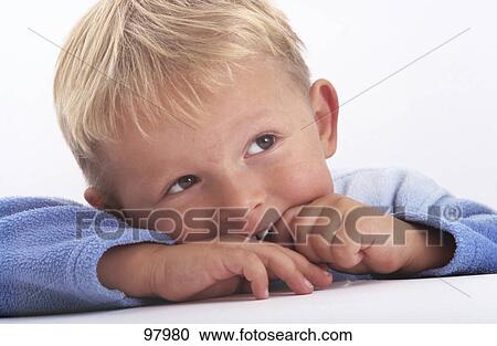Stock Image - Close-up of boy thinking . Fotosearch