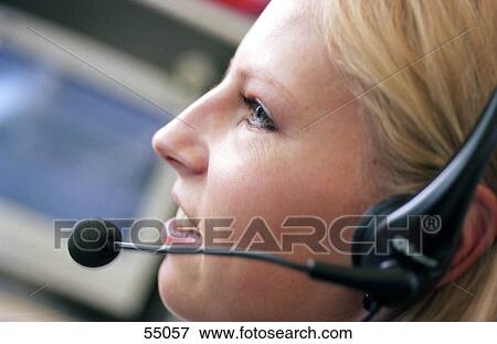 Close-up of businesswoman wearing headset View Large Photo Image Stock Photo - Close-up of businesswoman wearing headset . Fotosearch
