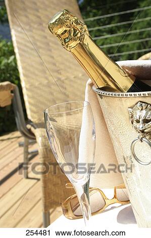 Close-up of champagne bottle in a champagne bucket on table View Large Photo Image Stock Image - Close-up of champagne bottle in a champagne bucket on table . Fotosearch