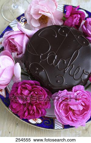 Stock Photography - Close-up of chocolate cake and rose flowers . Fotosearch