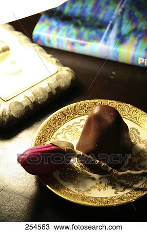 Stock Image - Close-up of chocolate cookie on plate . Fotosearch