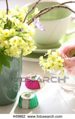 Stock Image - Close-up of cowslip flowers in vase . Fotosearch