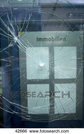 Stock Photograph - Close-up of cracked glass window . Fotosearch