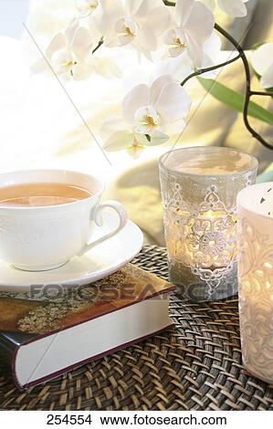 Close-up of cup of black tea on book View Large Photo Image Picture - Close-up of cup of black tea on book . Fotosearch