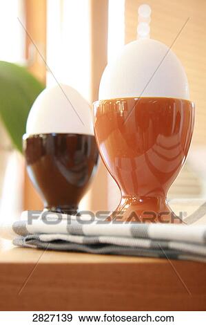 Stock Photo - Close-up of eggcups on table . Fotosearch