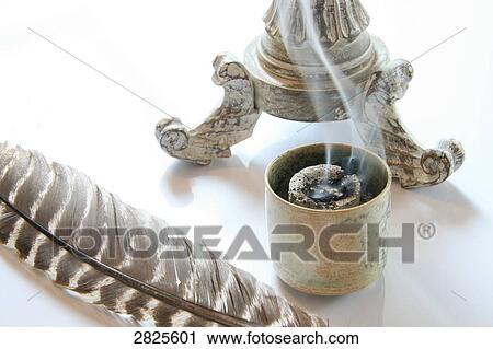 Stock Image - Close-up of feather and Joss stick . Fotosearch
