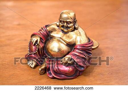 Close-up of figurine of laughing Buddha View Large Photo Image Stock Photo - Close-up of figurine of laughing Buddha . Fotosearch