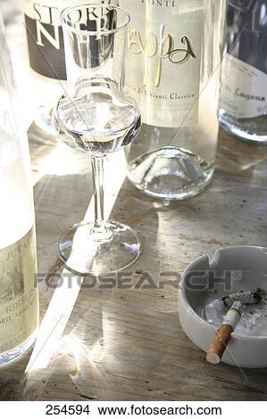 Close-up of glass and bottle of white wine View Large Photo Image Picture - Close-up of glass and bottle of white wine . Fotosearch
